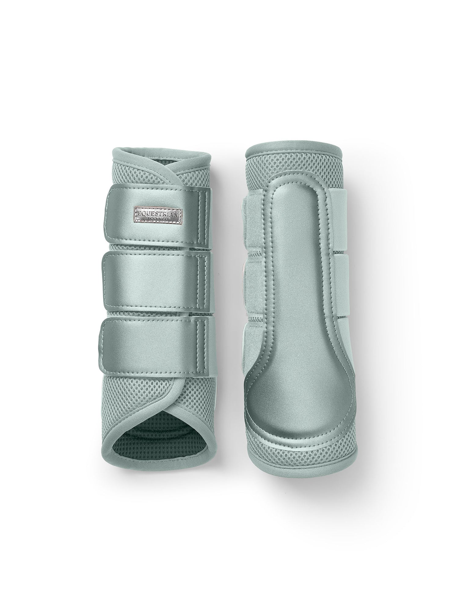 Studio image of Equestrian Stockholm Mesh Brushing Boots Mist Green with breathable 3D mesh and silver badge.
