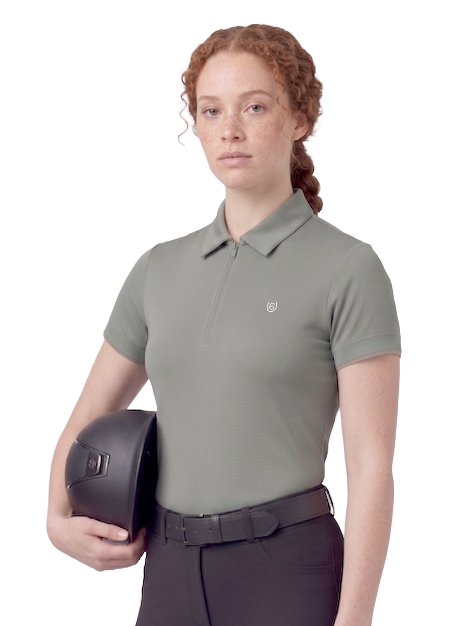 Equestrian Stockholm Short Sleeve Zip Top in Mist Green worn by a model with a riding helmet and black breeches.