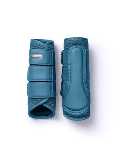 Studio image of Equestrian Stockholm Aurora Blues Mesh Brushing Boots featuring breathable 3D mesh and silver badge.