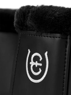 Studio image of Equestrian Stockholm Bell Boots Everyday Black with faux fur lining and white embroidered logo.
