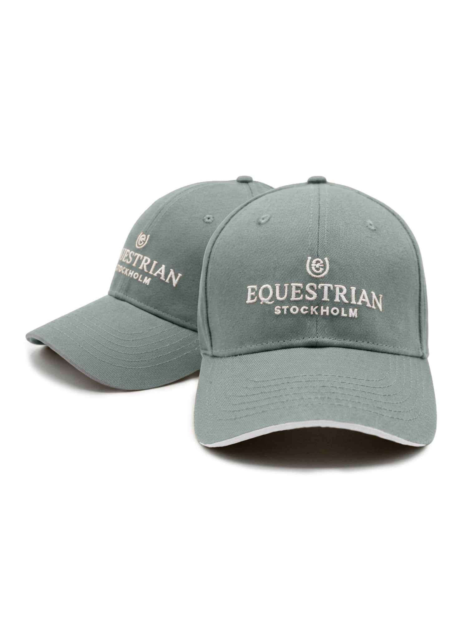 Studio image of two green Equestrian Stockholm caps with white embroidered logos and pre-curved brims.
