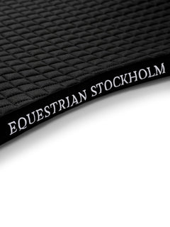 Studio image of Equestrian Stockholm black cotton saddle pad with square quilting and white logo embroidery