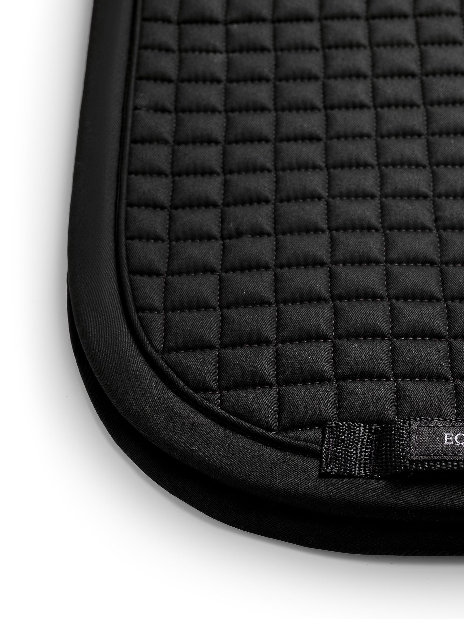 Studio image of Equestrian Stockholm Dressage Saddle Pad Cotton Black Germany featuring square quilting and a girth loop.