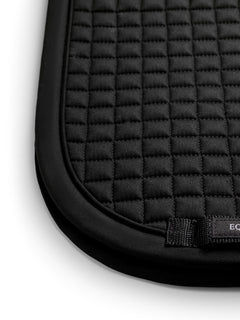 Studio image of Equestrian Stockholm Dressage Saddle Pad Cotton Black Germany featuring square quilting and a girth loop.
