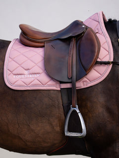Equestrian Stockholm Jump Saddle Pad Line Pink on a brown horse with a leather jump saddle and white logo embroidery.