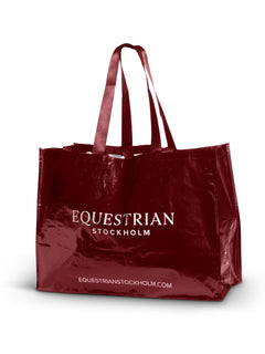 Studio image of Equestrian Stockholm Woven Stable Bag in Bordeaux with white logo and dual straps.